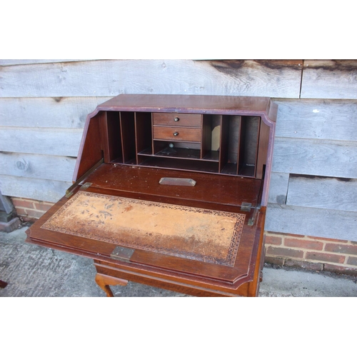 693 - A mahogany fall front bureau with fitted interior over three drawers, on cabriole claw and ball supp... 