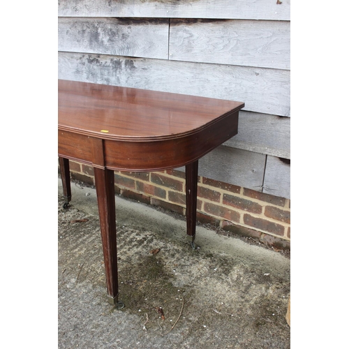 706 - A mahogany 'D' end table, on square taper supports, 47