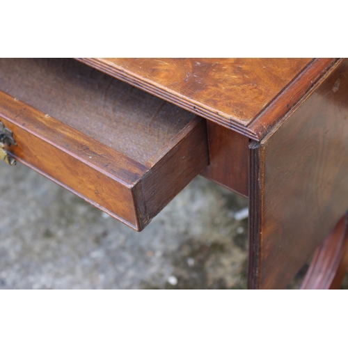 709 - A figured walnut flap top coffee table, fitted two drawers, on shaped supports, 27