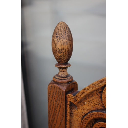 712 - A set of four carved light oak high backed dining chairs with upholstered floral pattern seats