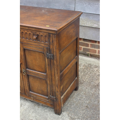 714 - A dark oak sideboard of 17th century design, fitted two drawers over cupboards enclosed panelled doo... 