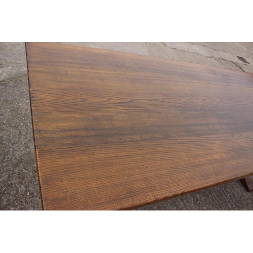 716 - An oak dining table with planked top, on square supports, 84