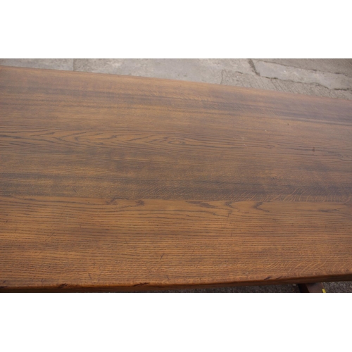 716 - An oak dining table with planked top, on square supports, 84