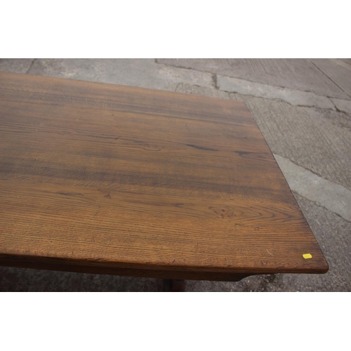 716 - An oak dining table with planked top, on square supports, 84