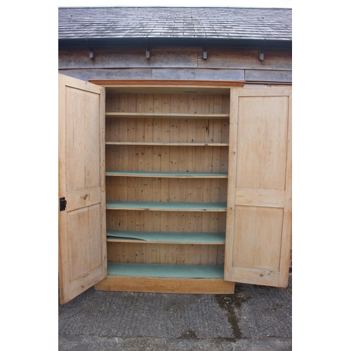 725 - A pine cupboard, fitted five shelves enclosed two doors,  on block base, 54