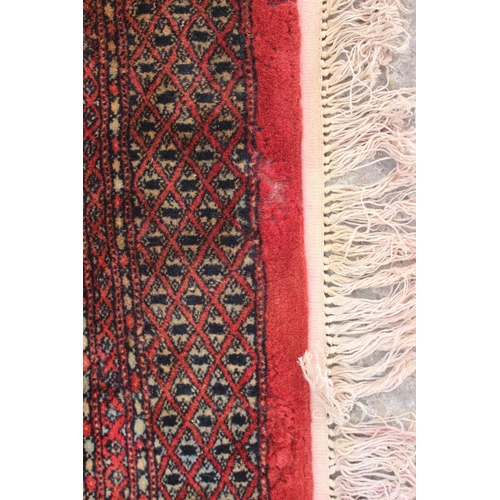 748 - A Bokhara carpet of traditional design with numerous octagonal guls on a red ground, 111