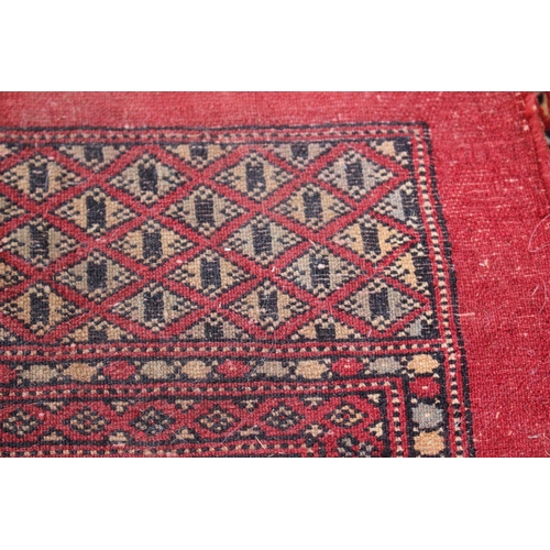 748 - A Bokhara carpet of traditional design with numerous octagonal guls on a red ground, 111