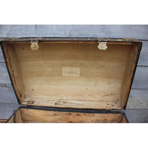 754 - A brass bound dome top trunk with wrought iron carry handles, 30