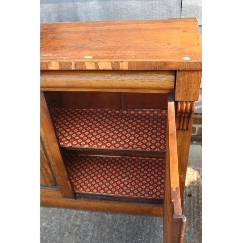 588 - A 19th century rosewood chiffonier, fitted frieze drawer over cupboard enclosed panelled doors, on b... 