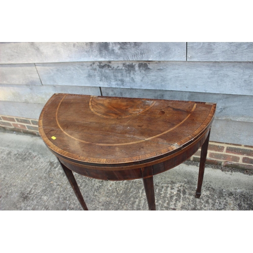 589 - A George III mahogany and banded 'D' shaped fold-over top card table, on square taper supports, 36