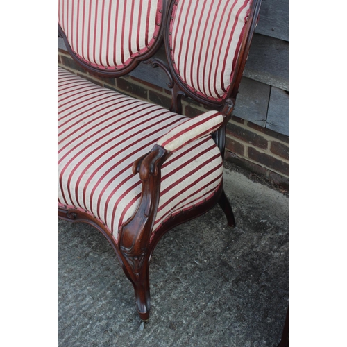 595 - A 19th century carved rosewood showframe three-seat settee with cameo back and stuffed over seat, up... 