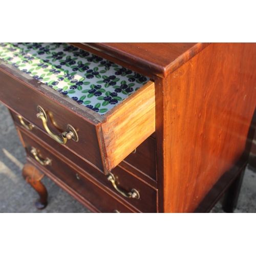 596 - An early 19th century mahogany ledge back chest of four long graduated drawers with brass bail handl... 