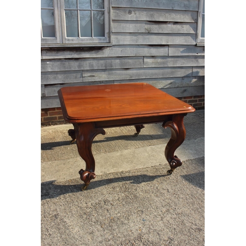 609 - A Victorian carved mahogany extending dining table with two extra leaves, on cabriole scroll support... 