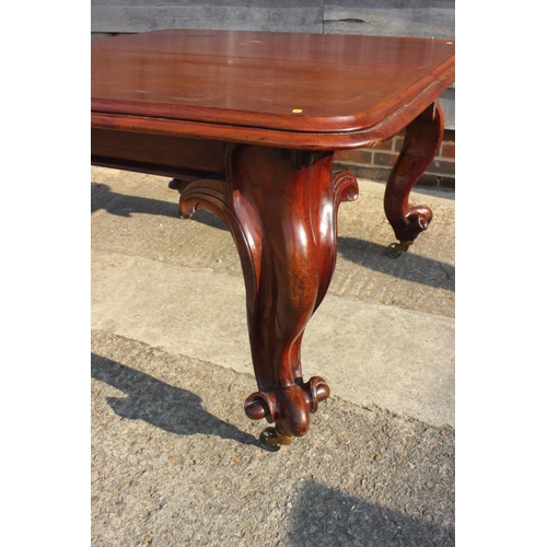 609 - A Victorian carved mahogany extending dining table with two extra leaves, on cabriole scroll support... 