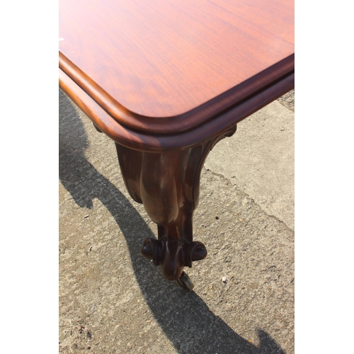 609 - A Victorian carved mahogany extending dining table with two extra leaves, on cabriole scroll support... 