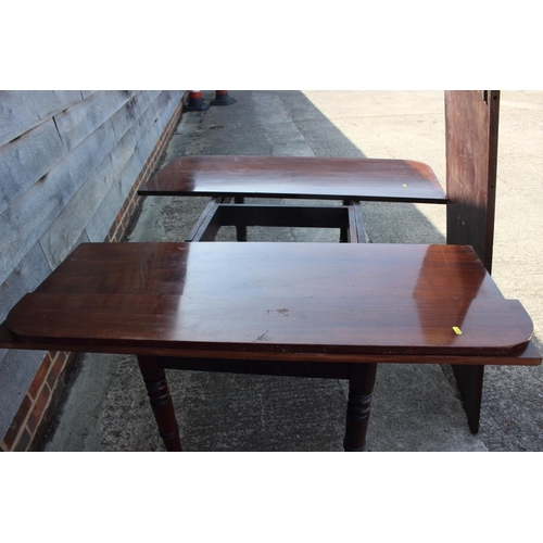 613 - A 19th century mahogany extending dining table with extra leaf, on slender turned and castored suppo... 