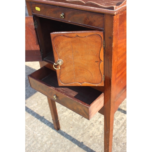 669 - A mahogany tray top bedside cabinet, fitted one drawer over cupboards and one further drawer, 17