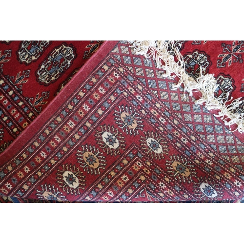 727 - A Bokhara rug of traditional design with seventy-five medallions and multi-borders, 112