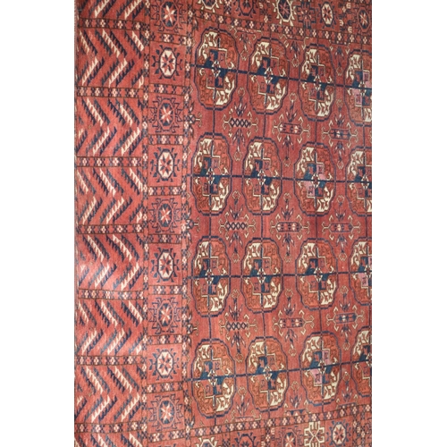 731 - An antique Bokhara rug with twenty-four guls in traditional shades, 43