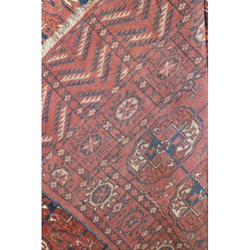 731 - An antique Bokhara rug with twenty-four guls in traditional shades, 43