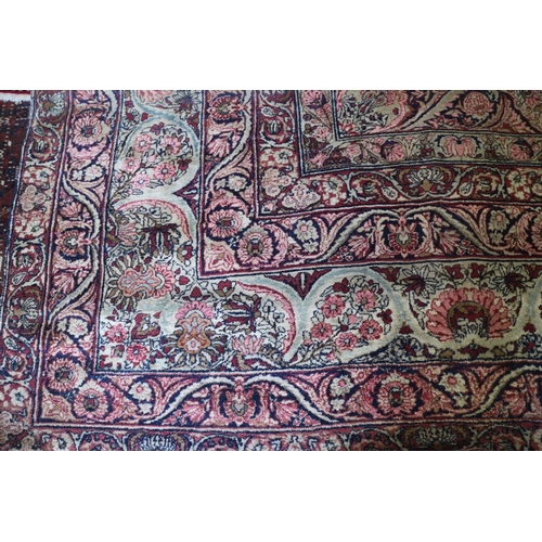 733 - A fragment of a Persian city carpet with part central medallion on scroll ground and six floral scro... 