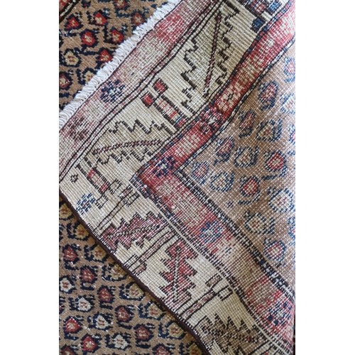 737 - A tribal runner with all-over boteh design on a camel ground and two geometric borders, in shades of... 