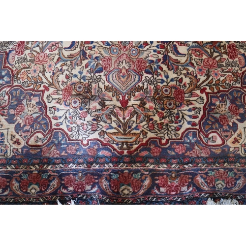 740 - A Kashan type rug with central medallion and all-over floral design on a cream ground, in shades of ... 