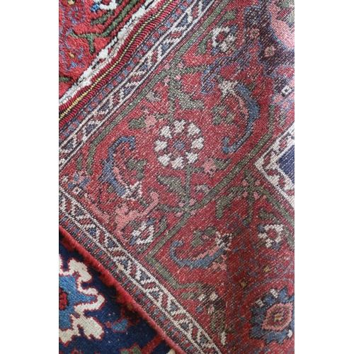 742 - A Tabriz runner with seven octagonal guls and six white rosettes on a blue ground with floral border... 