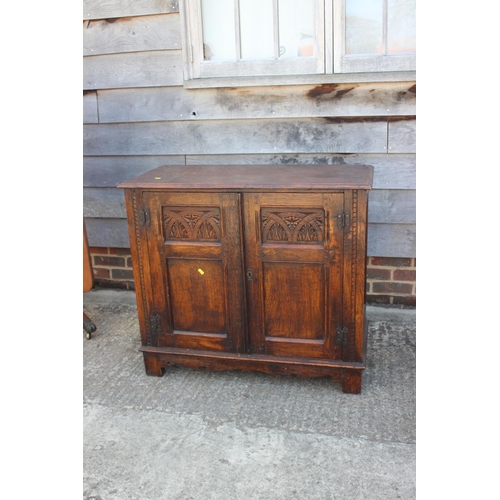 638 - An oak panelled cupboard of 17th century design enclosed two doors, on stile supports, 38