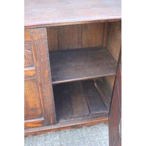 638 - An oak panelled cupboard of 17th century design enclosed two doors, on stile supports, 38