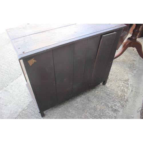 638 - An oak panelled cupboard of 17th century design enclosed two doors, on stile supports, 38