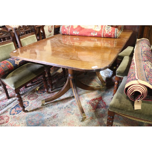 654 - A William Tillman mahogany extending double pedestal dining table with reeded edge and two extra lea... 