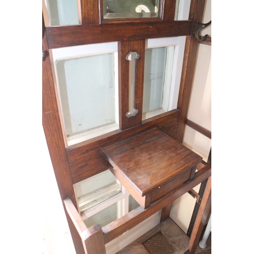 682 - An oak hall stand, fitted mirror and a glove box, 24