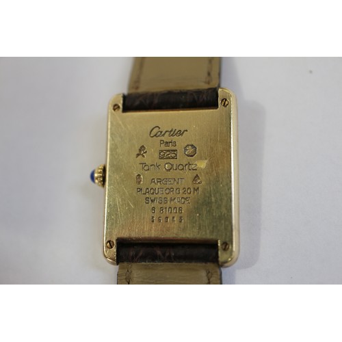 381 - A Cartier Tank Quartz silver gilt cased wristwatch with cream and gilt dial, and Roman numerals, on ... 