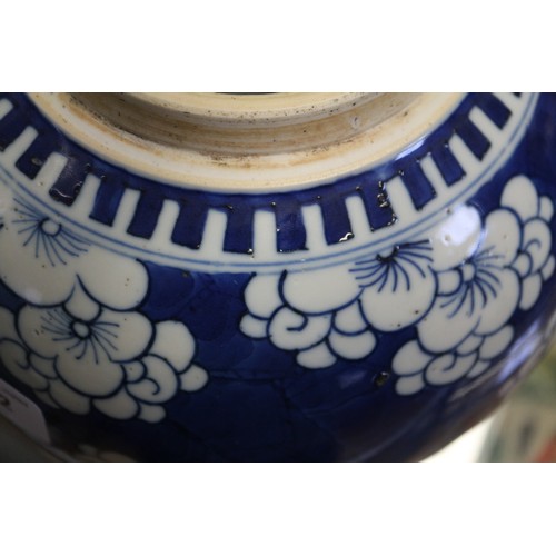 132 - A 19th century Chinese blue and white prunus decorated ginger jar with carved hardwood cover and sta... 