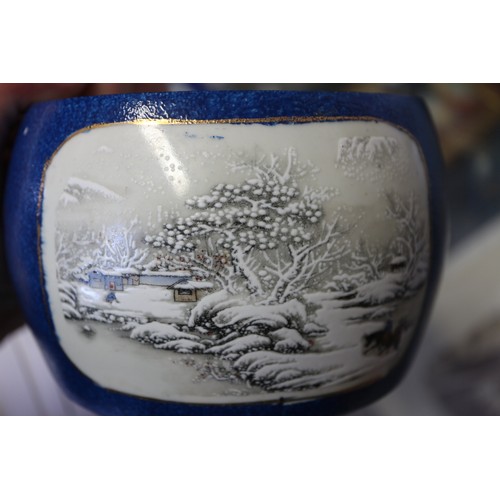 146 - A Chinese drum-shaped pot and cover with two panels decorated figures in landscapes on a blue glaze ... 