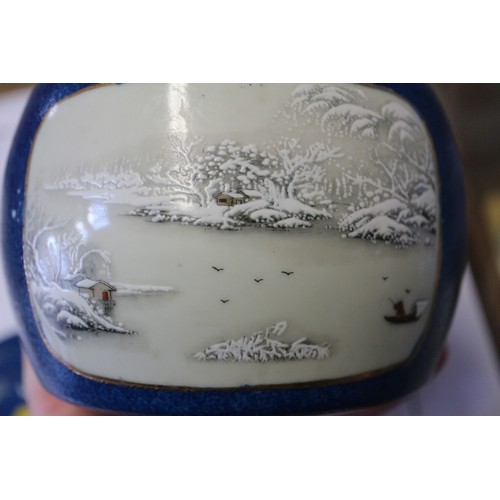 146 - A Chinese drum-shaped pot and cover with two panels decorated figures in landscapes on a blue glaze ... 