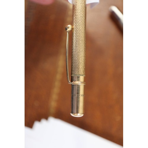 278 - A gold coloured Parker fountain pen, a rolled gold propelling pencil and a Burnham fountain pen