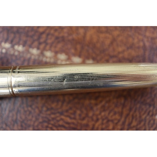 278 - A gold coloured Parker fountain pen, a rolled gold propelling pencil and a Burnham fountain pen