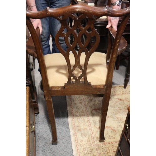 636 - A pair of carved mahogany elbow chairs of Chippendale design with pierced splat backs and drop-in se... 