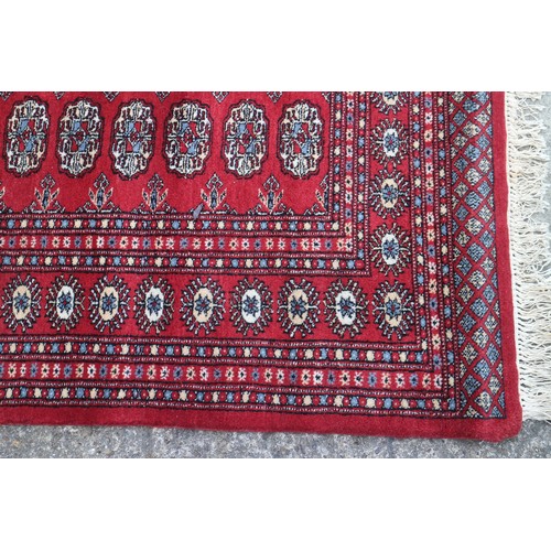 745 - A Bokhara rug of traditional design with eighty-four guls on a red ground, 98