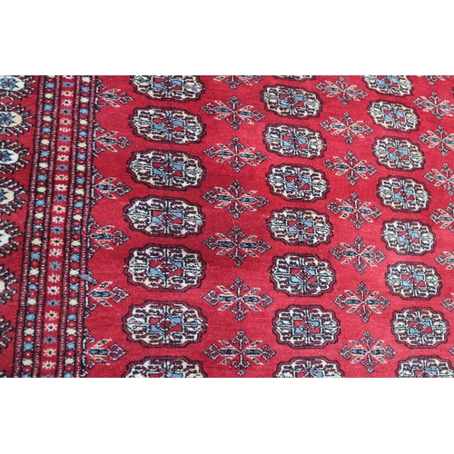 745 - A Bokhara rug of traditional design with eighty-four guls on a red ground, 98