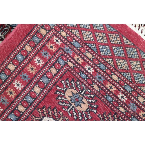 745 - A Bokhara rug of traditional design with eighty-four guls on a red ground, 98