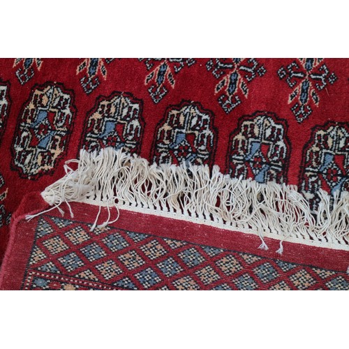 745 - A Bokhara rug of traditional design with eighty-four guls on a red ground, 98