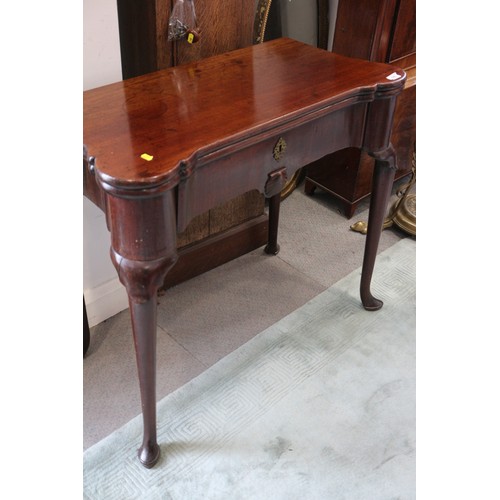 546 - An early George III mahogany fold-over top card table with counter wells and single gate, on shaped ... 