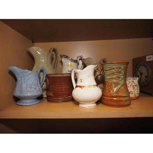 58 - Three relief decorated jugs, a 1953 Coronation mug, 5 1/4