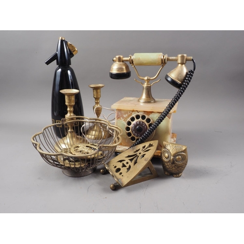 158 - An onyx and brass mounted rotary telephone, a pair of brass candlesticks, a soda siphon, horse brass... 