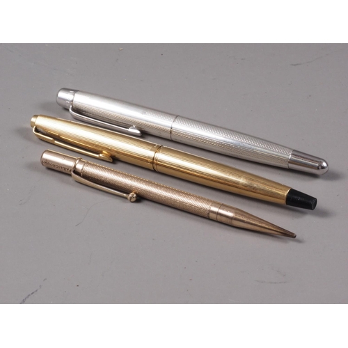 263 - A gold coloured Parker fountain pen, a rolled gold propelling pencil and a Burnham fountain pen