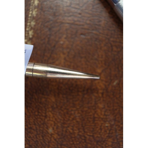 263 - A gold coloured Parker fountain pen, a rolled gold propelling pencil and a Burnham fountain pen