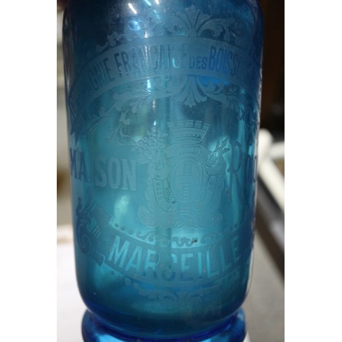 272 - A blue glass soda siphon, an amber glass soda siphon, two other soda siphons and an early 20th centu... 